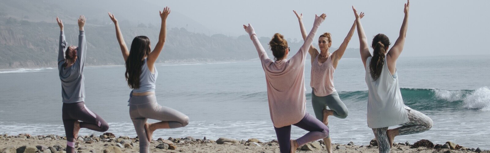 group yoga beside beach