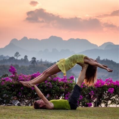 A couple doing yoga in the garden